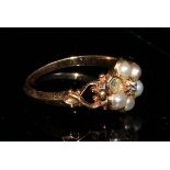 A Victorian gold flower head mourning ring, set with a central old cut diamond surrounded by five