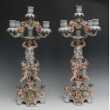 A pair of Continental figural five-light, four-branch candelabra, the columns with bare footed