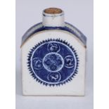 An 18th century Chinese porcelain tea caddy, painted in tones of underglaze blue with roundels, 11cm