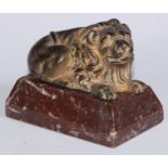 English School (early 19th century), a gilt bronze, of a recumbent lion, marble base, 13cm wide