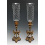 A pair of Regency gilt and parcel dark patinated bronze storm lanterns, each with Greek key collar