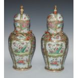 A pair of Cantonese baluster vases and covers, painted in the famille rose palette with figures,