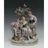 A 19th century Continental porcelain figural group, of two maidens and young male admirer beneath