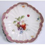 A German porcelain scalloped circular dish, painted in polychrome with fruit and flowers, puce