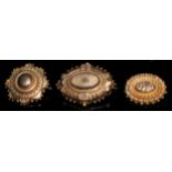 A late 19th century 9ct gold oval target brooch, 3cm, steel pin, marked 9ct, 2.5g; a 10ct gold