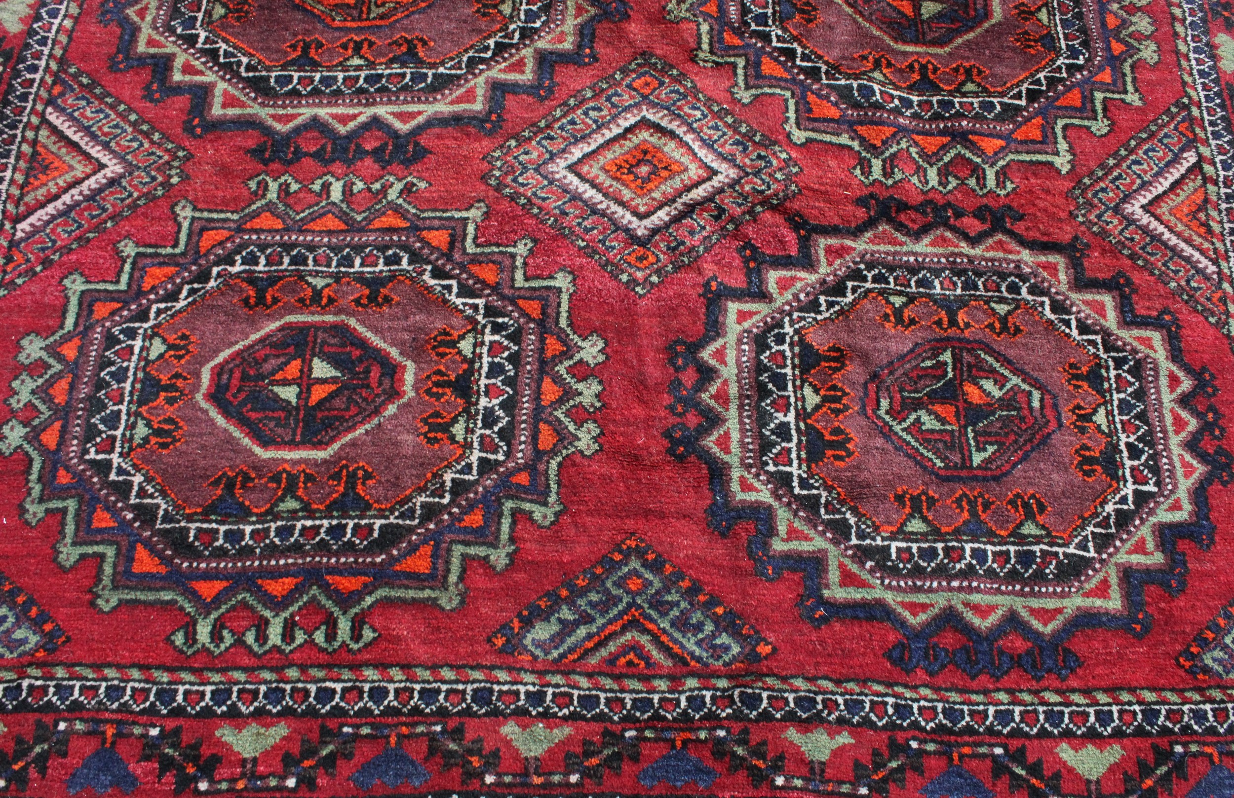 A Middle Eastern rectangular wool rug or carpet, the field worked with hooked medallions and - Image 4 of 5