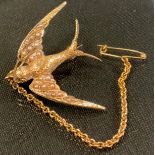 A 15ct gold seed pearl Swallow brooch, modelled in full flight,, 31mm x 26mm, stamped 15ct, 3.6g