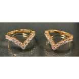 A pair of diamond V rings, each inset with eleven round brilliant cut diamonds, total estimated