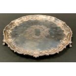 A Victorian silver salver, engraved and chased to centre, the rim embossed with scrolls, beaded rim,
