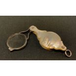 A silver and mother-of-pearl folding eye glass, 8cm wide, unmarked