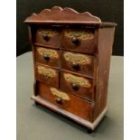 An early 20th century stained pine spice chest, six short over single long drawer, each labelled,