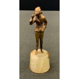 Art Deco, a gilt bronze, miniature, of a lady asking for silence, onyx base, 10.5cm high