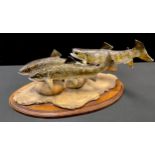 A Peter Lowerson sculpture, Three Trouts, signed, dated 1997, 24.5cm high, 44cm long, oval plinth