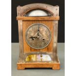 An Arts and Crafts oak and brass mounted mantel clock, for Liberty & Co, 14cm dial cast with