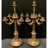 A pair of Gothic Revival brass five-light four-branch candlesticks, in the manner of Augustus