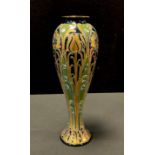 A Mcintyre Florian Ware slender ovoid vase, tube lined with tulips and flowers in gilt, with sinuous
