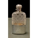 An Edwardian silver mounted hobnail-cut glass hip flask, hinged bayonet cover chased with