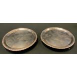 A pair of early George III silver shaped circular salvers, gadrooned borders, armorial fields,