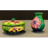 A Moorcroft Hibiscus pattern trinket pot and cover, tube lined with large flowerheads in tones of