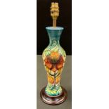 A contemporary Moorcroft Arum Lily pattern baluster lamp base, designed by Nicola Slaney, tube lined