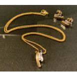 A diamond set 9ct gold pendant and earrings suit, two tone white and yellow ribbon mounts, the suite