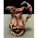 A 19th century stoneware game jug, in relief with dead game, greyhound loop handle, 22cm high, c.