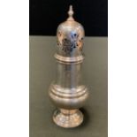 A silver caster, domed pierced cover, spreading circular base, 17cm high, Viners, Sheffield 1942,