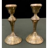 A pair of Elizabeth II silver candlesticks, campana sconces, reeded borders, 18cm high, Birmingham