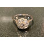 A diamond cluster ring, central old brilliant cut diamond approx 0.50ct surrounded by eight