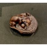 A carved wooden netsuke, as a Cat chasing a Mouse in a Basket, unsigned, 4.7cm long