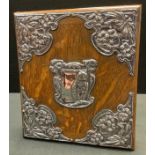 An Art Nouveau silver mounted oak blotter, the fittings embossed with an owl, stylised flowers and