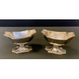 A pair of George III silver pedestal boat shaped salts, fluted incurved angles, 6.5cm high, John