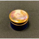 A Royal Worcester cylindrical box, the cover painted by Rushton, signed with castle, lake and