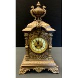 A 19th century gilt metal mantel clock, the 11cm diam with Arabic numerals, twin winding holes,