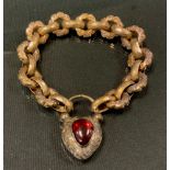 A Victorian floral cast and facetted link mourning bracelet, with pear cabochon foil backed garnet