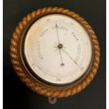 A Victorian oak circular barometer, carved rope twist border, 27cm diam, c.1880