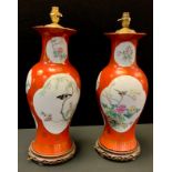 A pair of Chinese baluster lamps, decorated with song birds in flight and perched and blossoming