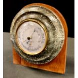 A 20th century serpentine Cornish Lizardite aneroid barometer, 17cm diam, mounted