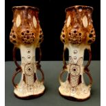 A pair of Werke Reissner Amphora "Espaniola" pierced two handled vases, picked out in tan, 31cm