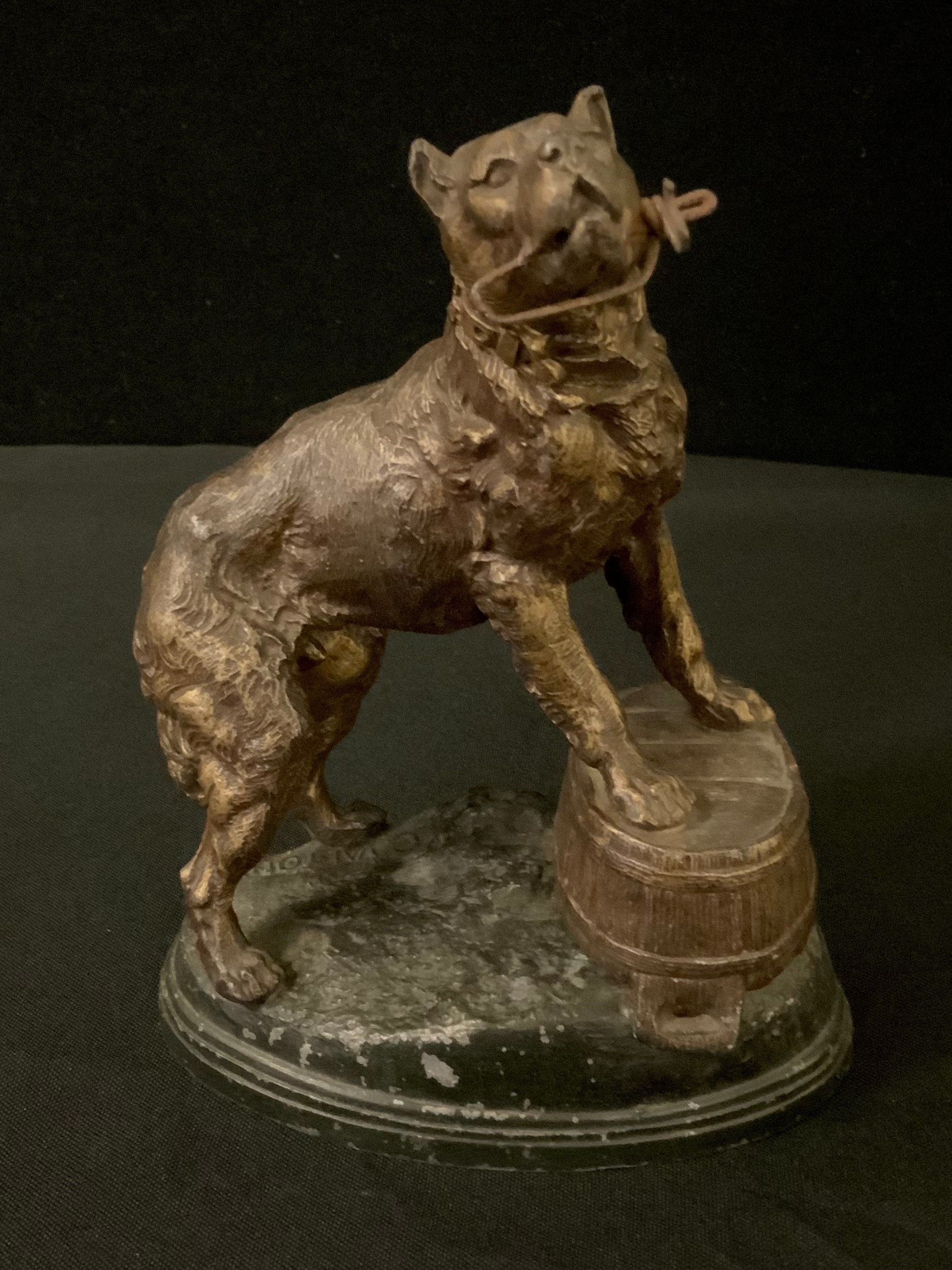 A French spelter watch stand, cast with a Beaucerron, standing on an upturned coopered tub, rocky