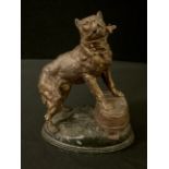 A French spelter watch stand, cast with a Beaucerron, standing on an upturned coopered tub, rocky