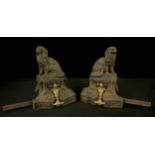 A pair of French cast iron chenets, cast with Toy Spaniels, on a shaped rectangular pedestal,