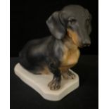 A Herend Hungary modle, of a Dachshund, canted square base, 15.5cm high, printed mark