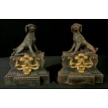 A pair of French cast iron chenets, cast with Poodles, on a shaped rectangular pedestal, applied