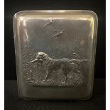 An early 20th century rounded rectangular plated cigarette box, the cover embossed with Retriever