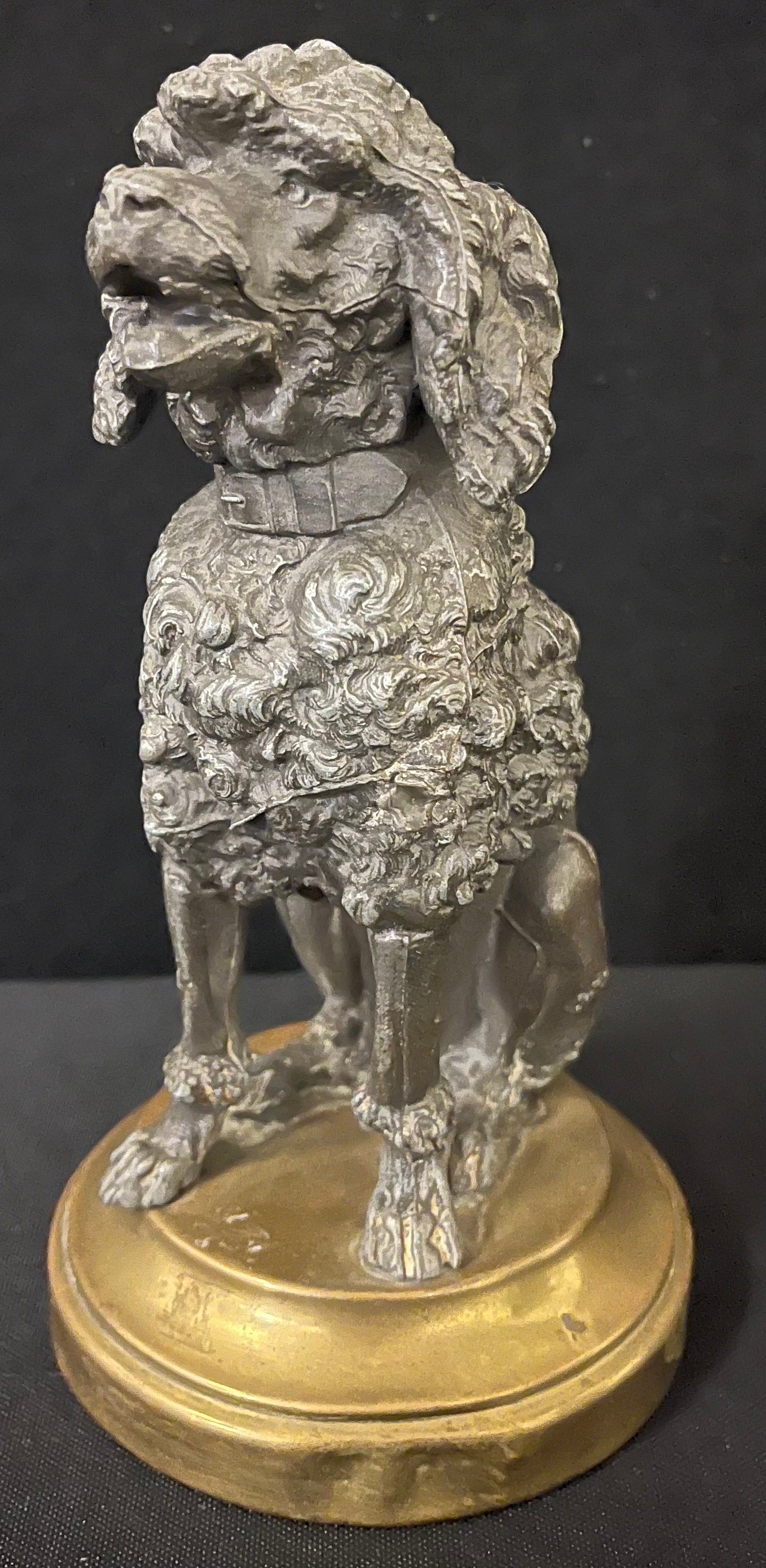 A late 19th century French spelter model, of a Poodle, seated, gilt metal circular base, 13cm