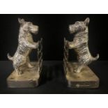 A pair of chrome plated bookends, cast with Scottish terriers at a fence, 14cm high, c.1930