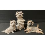 A Eve Pearce model of a West Highland Terrier, 12cm high; another, 7.5cm high; a similar Cairn