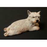 A Basil Matthews model, of a West Highland puppy, reclining, 11.5cm wide, label