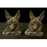 A pair of early 20th cenrtury brass bookends, cast with Alsatian heads, 13.5cm high